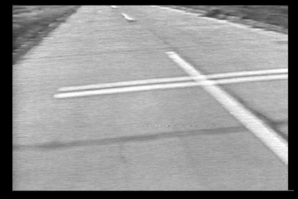 UN MILE DE CROIX JONCHANT LA ROUTE/ONE MILE OF CROSSES UPON THE PAVEMENT